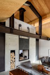 The fireplace core is by Earthcore Industries (Isokern, Magnum 48 See-Thru.) Olson Kundig gizmologist Phil Turner designed the custom concrete surround, steel chimney flue, and rolling steel fireplace screens.&nbsp;