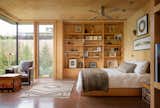 A look inside the master bedroom, which is finished with natural, unstained plywood walls and ceilings, as well as terra cotta-tinted concrete floors.&nbsp;&nbsp;