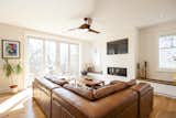 Living Room, Sectional, Console Tables, Coffee Tables, Ceiling Lighting, Medium Hardwood Floor, Accent Lighting, Ribbon Fireplace, and Gas Burning Fireplace Edwardian Renovation - Great Room  Photo 5 of 20 in Edwardian Renovation by Solares Architecture