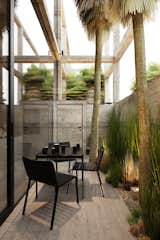
A minimalist outdoor space blending natural elements with modern design, featuring sleek black furniture and lush greenery. #mb3h #outdoorliving #minimalistdesign #modernarchitecture
