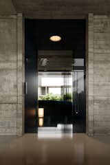 
A seamless blend of sleek modern finishes and industrial elements, this bathroom offers a contemporary and peaceful atmosphere with beautiful views of nature. #mb3h #modernbathroom #concretedesign #minimalism