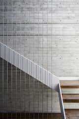 The staircase provides a central, vertical axis between the upper and lower levels.