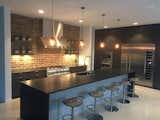 Modern industrial kitchen with Thermador appliances, Stevenswood cabinets and black leathered granite countertops.  Photo 3 of 8 in Industrial Modern Home built by husband and wife team by Renee' Criswell Champion