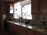 Kitchen area with gas stove, granite counters, dishwasher and huge window to see all the critters  Photo 2 of 17 in Caliente Creek Ranch by Barbara Mary Powell