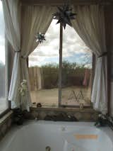 Relaxing hot tub in master bath looking out at the desert  Photo 7 of 17 in Caliente Creek Ranch by Barbara Mary Powell