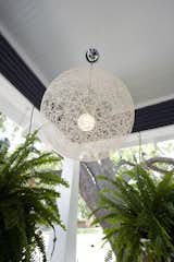 Modern lighting on the front porch updates this historic home  Photo 4 of 16 in Historic Bungalow by LeavittHaas
