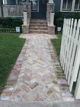 A new walkway with the antique Chicago brick in the framed herringbone layout provided a lush entrance through the gate.
