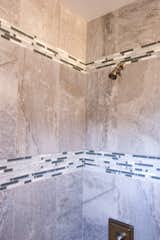 The bathroom was updated with modern finishes, while tile was used in a unique banding stripe to provide interest while saving money.  Photo 9 of 10 in Asian Bungalow - Garden Apartment by LeavittHaas