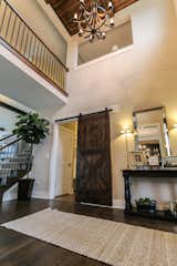 Dramatic two story foyer with stained coffered ceiling detail and barn sliding door