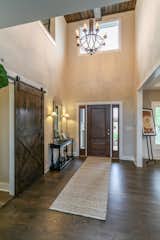 Dramatic two story foyer with coffered ceiling detail and barn sliding door