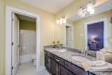 Bath Room, Granite Counter, Ceramic Tile Floor, Corner Shower, Wall Lighting, Two Piece Toilet, Undermount Sink, and Open Shower Jack and Jill Bath  Photo 2 of 17 in The Parker II Eco-Smart Model Home by DJK Custom Homes, Inc.