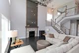Open and Airy Two Story Great Room with Powder Coated Sheet Metal Detail on Fireplace Face