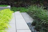 Plantings Meet Stone at Edge  Search “heavenly backyard precise pebbles” from Modern Linear Courtyard