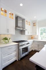 Warm wood floors added to crisp kitchen renovation.  Photo 15 of 15 in Kitchens by Rill Architects