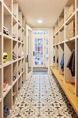Mudroom with concrete tile and individual cubbies