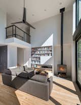 Living Room, Sectional, Recessed Lighting, Light Hardwood Floor, and Wood Burning Fireplace  Photo 9 of 18 in Mountain Retreat by Catherine Truman Architects