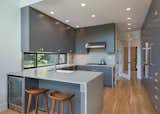 Kitchen, Refrigerator, Wall Oven, Light Hardwood Floor, Recessed Lighting, Colorful Cabinet, and Drop In Sink  Photo 13 of 18 in Mountain Retreat by Catherine Truman Architects