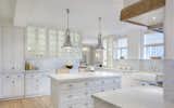 Kitchen, Ceiling Lighting, Light Hardwood Floor, White Cabinet, Drop In Sink, and Pendant Lighting Beacon Street Apartment  Photo 3 of 13 in Beacon Street Apartment by Catherine Truman Architects
