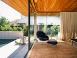 Bedroom, Bench, Medium Hardwood Floor, Chair, Ceiling Lighting, and Rug Floor  Photo 19 of 32 in Vertex House by M Gooden Design