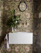 Floral wallpaper adds extra flair to the home's small powder room.