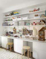On the second floor, long, open shelves in the kids' bedroom help foster a clutter-free zone.