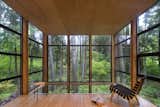 The feeling of being enveloped in the forest is heightened by windows that extend a couple of inches above the slightly dropped hemlock ceiling. This space was originally going to contain the master bedroom until the Owner realized that the view—and the feeling of being in a treehouse—was too magical to waste on a room used for sleeping.