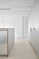 Kitchen, Engineered Quartz Counter, Refrigerator, Ceiling Lighting, Metal Cabinet, and Porcelain Tile Floor  Photo 4 of 18 in ÁVILA by Allaround Lab
