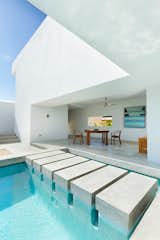 Designed by Campos Leckie to invoke a pure, dream-like quality, this minimalist retreat is situated on a hill above Zippers Beach overlooking the Sea of Cortez. The bold geometric angles, stripped down interior, and whitewashed walls allow for maximum light and shadow play throughout the day. The home features a Zen garden, central pool, and a rooftop patio with sweeping views of the ocean and mountains.