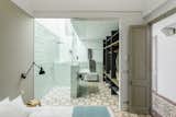 Bath Room, Ceramic Tile Floor, Wall Mount Sink, Open Shower, and Porcelain Tile Wall  Photo 7 of 16 in A Careful Renovation Brings New Life to a Family’s Heritage Home on the Spanish Coast