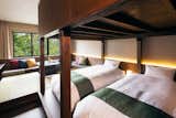 Bedroom, Bunks, Dark Hardwood Floor, and Wall Lighting  Photo 3 of 8 in Hoshino Resorts KAI Alps by Dwell from This New Japanese Resort Offers Access to Hot Springs and Pristine Alpine Skiing