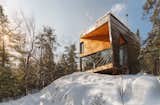 I-Kanda Architects designed Cabin on a Rock, a modernist, prefab cabin in New Hampshire’s White Mountains. "The 900-square-foot cabin perches on one piece of granite, projecting precariously over a steep drop-off to afford dramatic eastern views across the valley below," says architect Isamu Kanda, principal at the Boston firm.