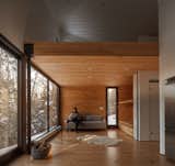 Living Room, Ceiling Lighting, Recessed Lighting, Sofa, Medium Hardwood Floor, and Chair  Photo 13 of 18 in A Prefab Cabin in New Hampshire Is a Magnificent Mountain Retreat