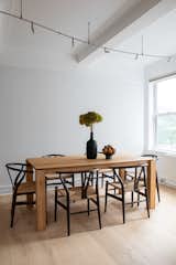 The combination of filtered natural light and light hardwood flooring make for a bright and airy dining area. 