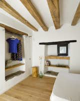 Rough-hewn finishes in the first-floor bedroom speak to the farmhouse character.