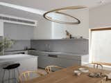 The wedge-shaped cut extends to the kitchen, allowing natural light to cascade throughout the interior.
