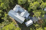 An Aerial view of the home shows its hilltop position and the privacy afforded by the surrounding indigenous coastal landscape. Custom Home Builder Deron Strickman-Levitas for Luke & Blues.