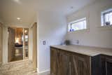 The bricks in the underfloor heated hallway came from an old chimney previously attached to the back of the building which had to be dismantled. Old barn board and new maple are used in partnership for the doors.