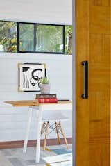 A custom barn door, made by the owners, adds a decorative element and warmth