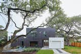 In Austin, Texas, this 1,100-square-foot accessory dwelling unit, called The Chelsea, splits a lot with the main house. The ADU responds to the lot by dodging the heritage trees to the north while creating a very spacious front yard. There is a garage that blocks a dogtrot and the living area of the house from the setting sun; the larger windows are concentrated on the northern side of the lot for plenty of natural lighting while reducing the heat gain in the summer and encouraging passive cross-ventilation.
