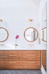 Master Bathroom - The master bathroom further draws from the Mid-century roots of the surrounding area. Warm walnut and brass provide a striking contrast with charcoal gray floors. 