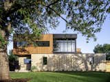 The front facade of the house boasts a douglas fir box resting on a masonry plinth. 