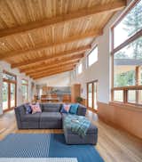 The great room, housed under a dramatic tongue and groove Cedar soffit, is flanked by views towards the East and West.