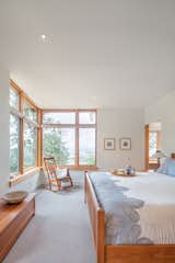 Full height corner windows in the master bedroom frame views towards the Yamhill Valley beyond.