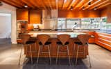 The kitchen features Mahogany cabinetry, dark granite counters  and counter height windows with views towards the backyard.