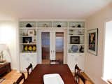 Bi-parting pocket doors create an elegant transition with storage from dining to kitchen.