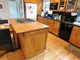 A re-configured kitchen island houses the new downdraft range hood from The Appliance Center.
