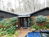 New steel porch structure with metal roof is a pleasant change from the old faded awning.
