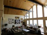 We added a door, replaced a few broken-seal units, and added tongue and groove pine ceiling and beam wrap to this 2-story living room with loft.