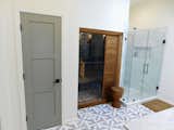 Master bath with frameless glass tile shower and cedar spa unit from Sunlighten.