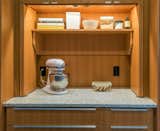 This appliance garage lives left of the refrigerator and wall oven, with extremely functional folding doors and a shelf for storage.